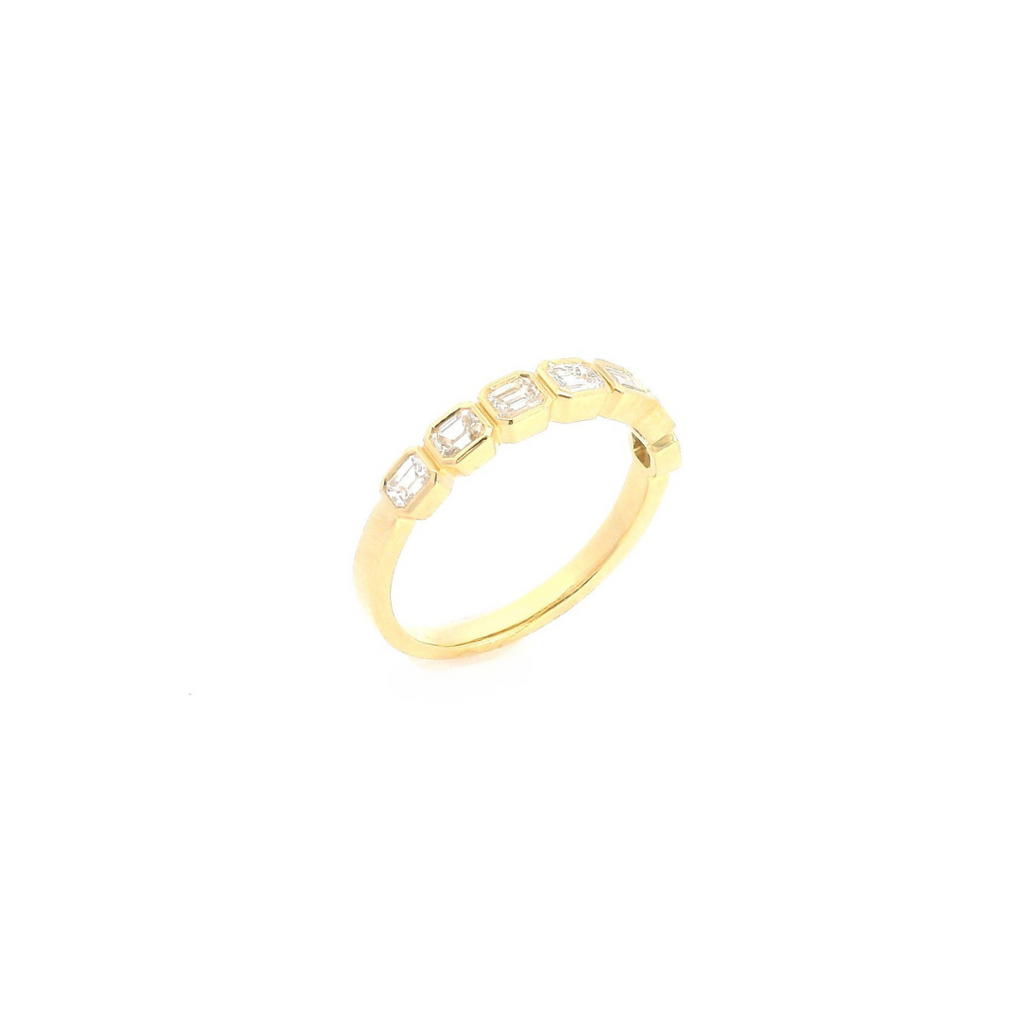 18ct yellow gold diamond ring featuring seven horizontally set emerald cut diamonds in individual bezel settings across the top.