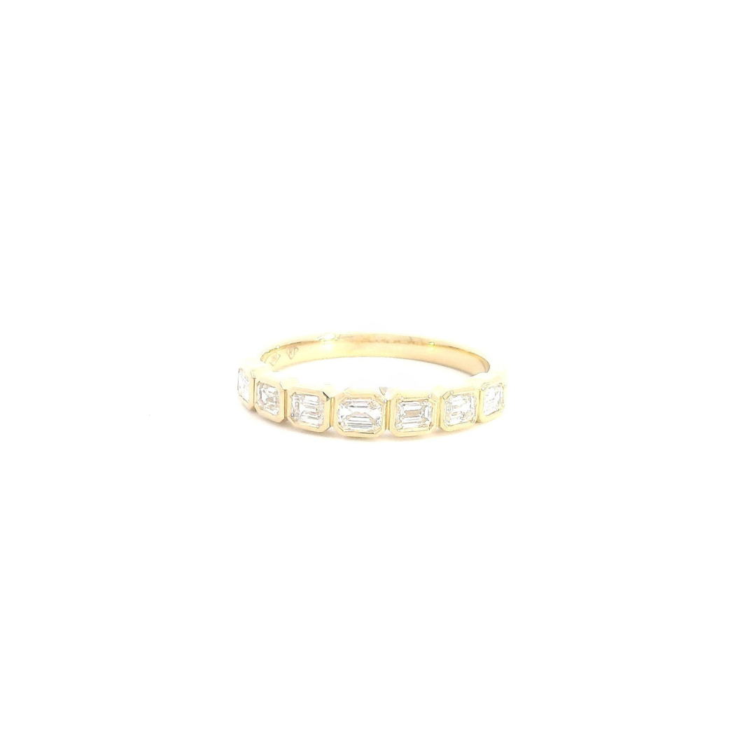 18ct yellow gold diamond ring featuring seven horizontally set emerald cut diamonds in individual bezel settings across the top.