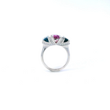 18ct white gold ring featuring a 2.11ct emerald cut purple-pink Malaia garnet with two greenish-blue tourmalines and diamond-set tiered claw and bar details.