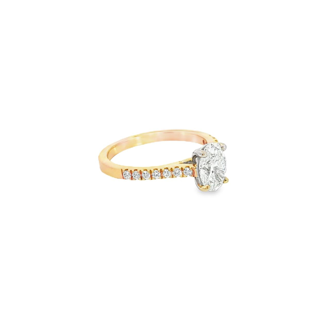 18ct rose and white gold diamond ring featuring a 1.02ct E/SI2 oval cut diamond in a white gold four-claw setting with diamond-set shoulders.