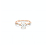 18ct rose and white gold diamond ring featuring a 1.02ct E/SI2 oval cut diamond in a white gold four-claw setting with diamond-set shoulders.