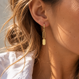 9ct yellow gold drop earrings featuring hinged huggies, elongated facetted oval links and polished flat oval disc drops.