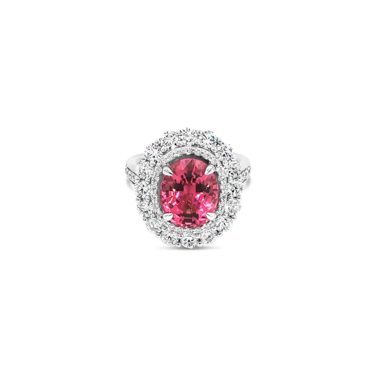18ct white gold ring featuring a 3.66ct oval cut pink tourmaline surrounded by double diamond halos with diamond-set shoulders.
