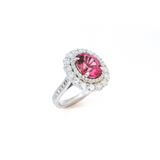 18ct white gold ring featuring a 3.66ct oval cut pink tourmaline surrounded by double diamond halos with diamond-set shoulders.