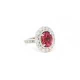 18ct white gold ring featuring a 3.66ct oval cut pink tourmaline surrounded by double diamond halos with diamond-set shoulders.