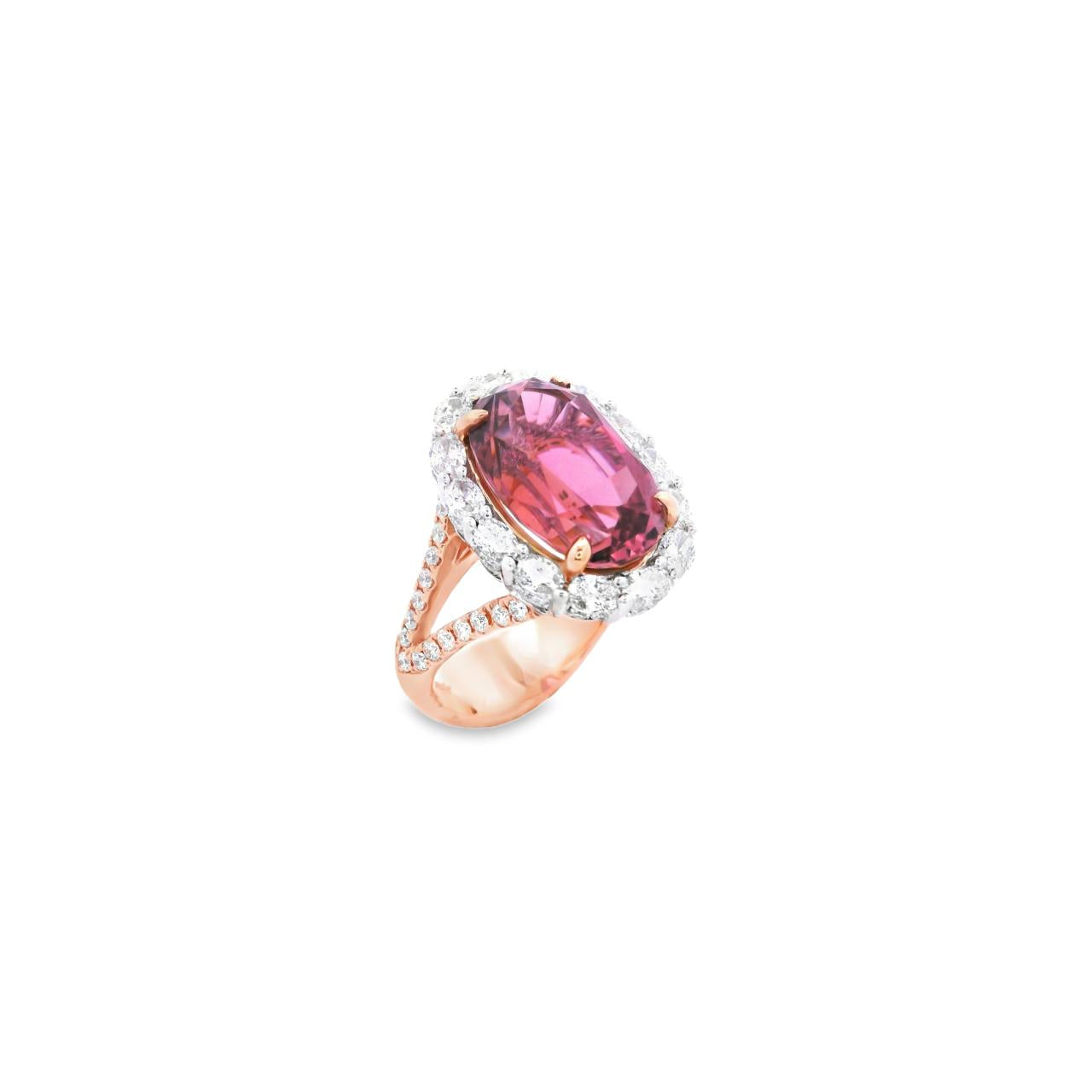 18ct rose and white gold ring featuring a 9.25ct oval pink tourmaline surrounded by a halo of diamonds, with rubies bead set into the undercarriage and split claw shoulders.