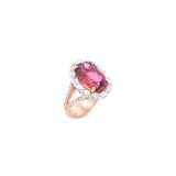 18ct rose and white gold ring featuring a 9.25ct oval pink tourmaline surrounded by a halo of diamonds, with rubies bead set into the undercarriage and split claw shoulders.