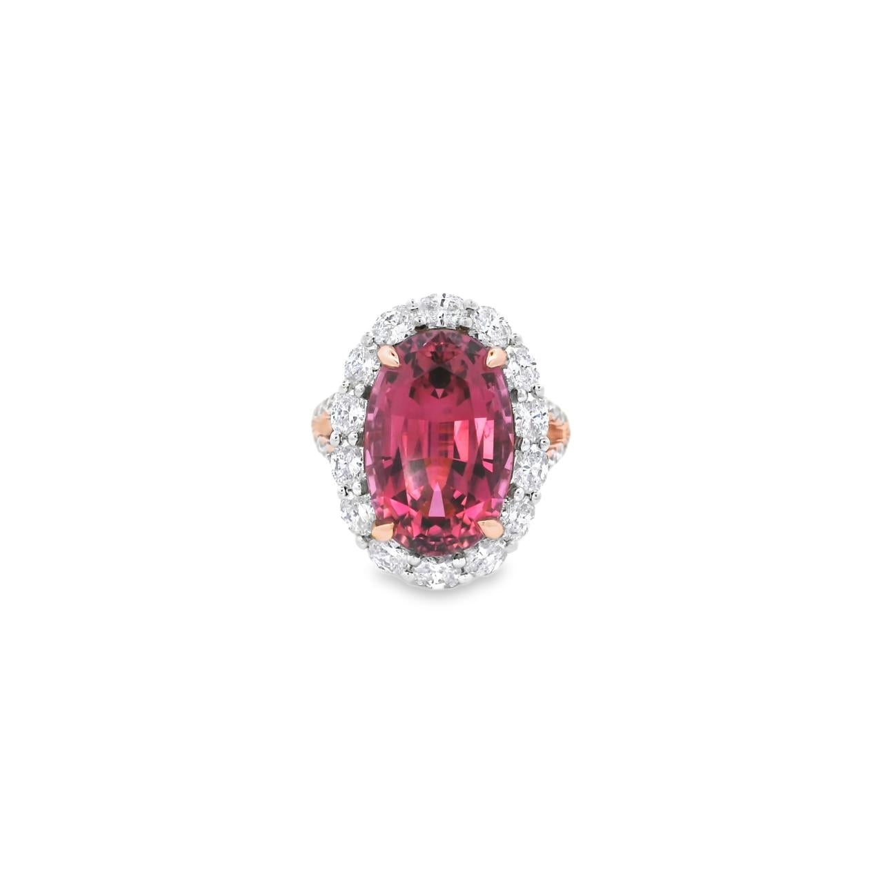 18ct rose and white gold ring featuring a 9.25ct oval pink tourmaline surrounded by a halo of diamonds, with rubies bead set into the undercarriage and split claw shoulders.