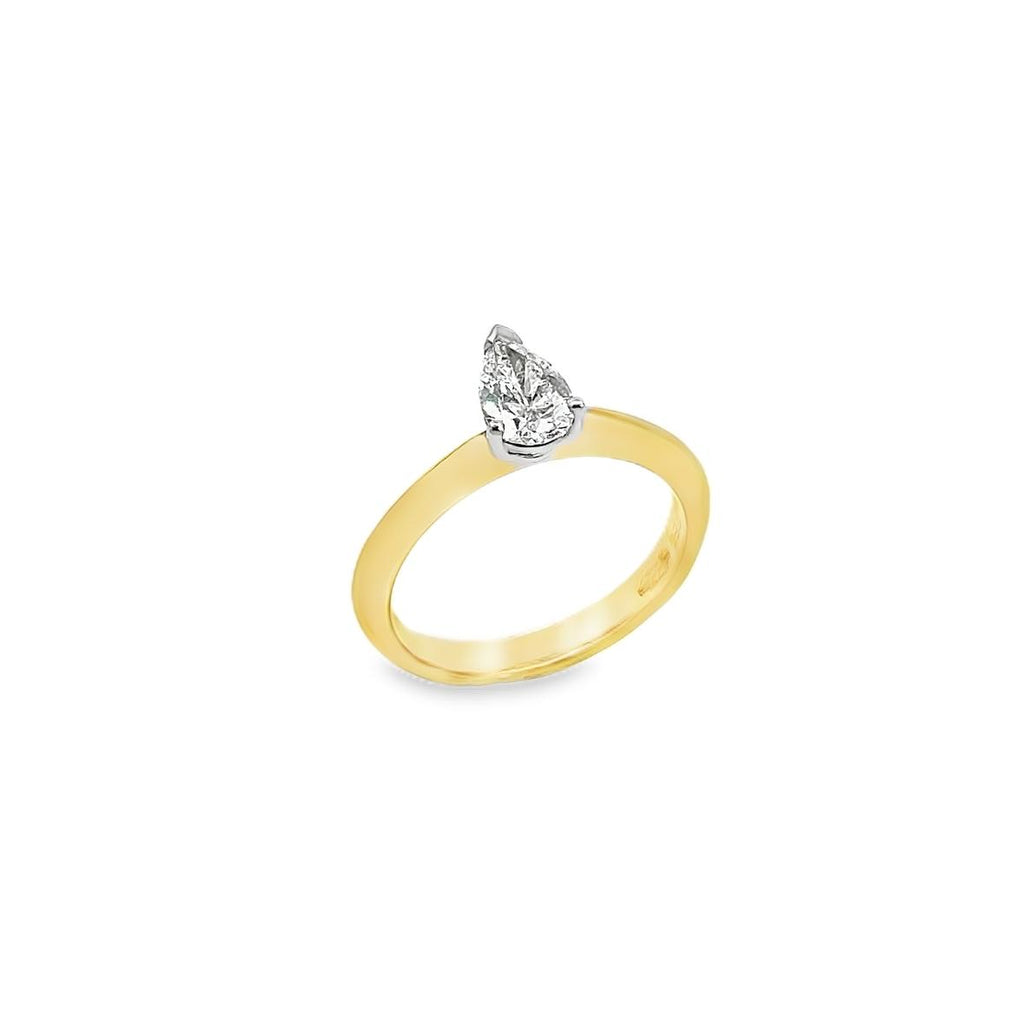 18ct yellow and white gold pear shaped solitaire diamond ring with claw and V-cap setting and French curve shoulders.