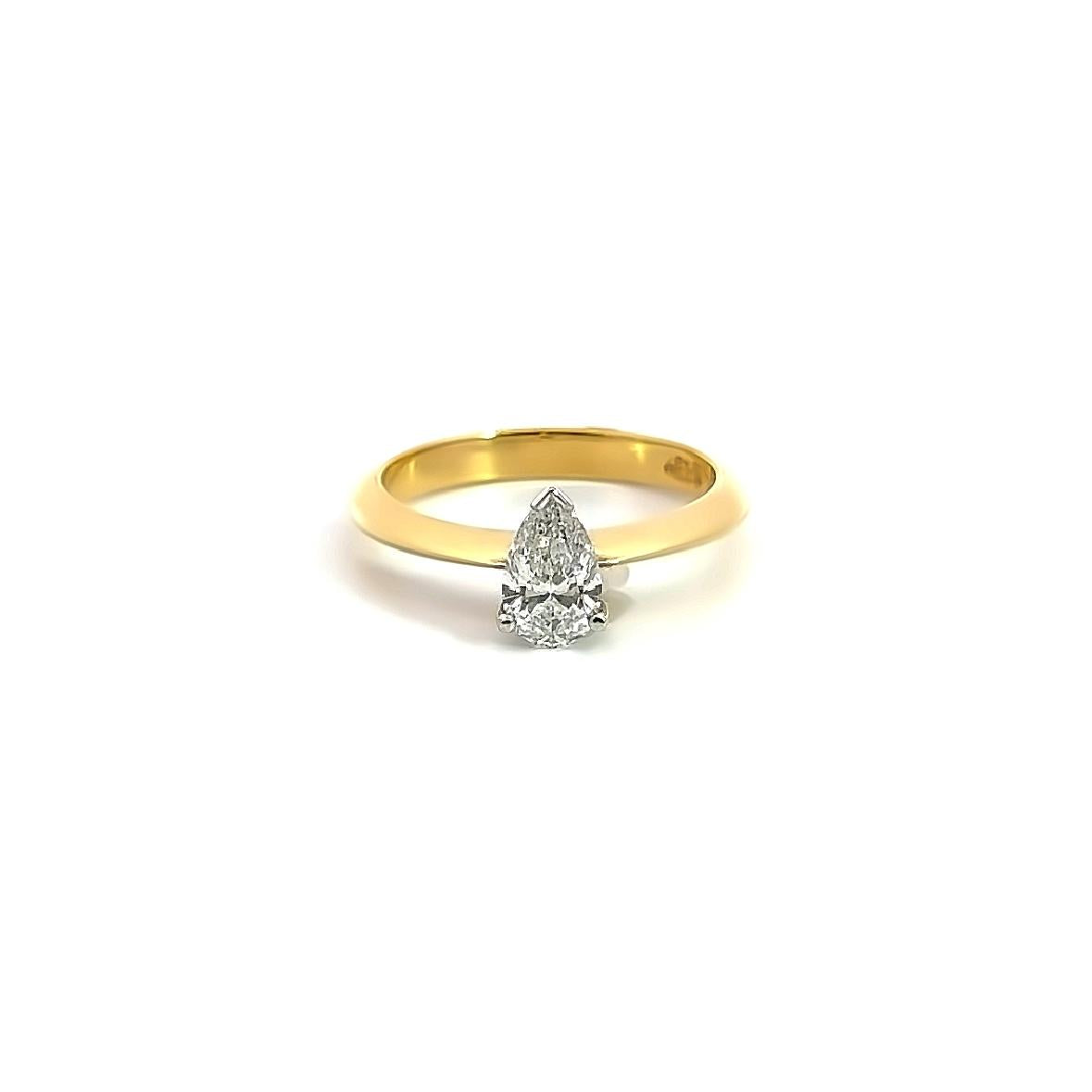 18ct yellow and white gold pear shaped solitaire diamond ring with claw and V-cap setting and French curve shoulders.