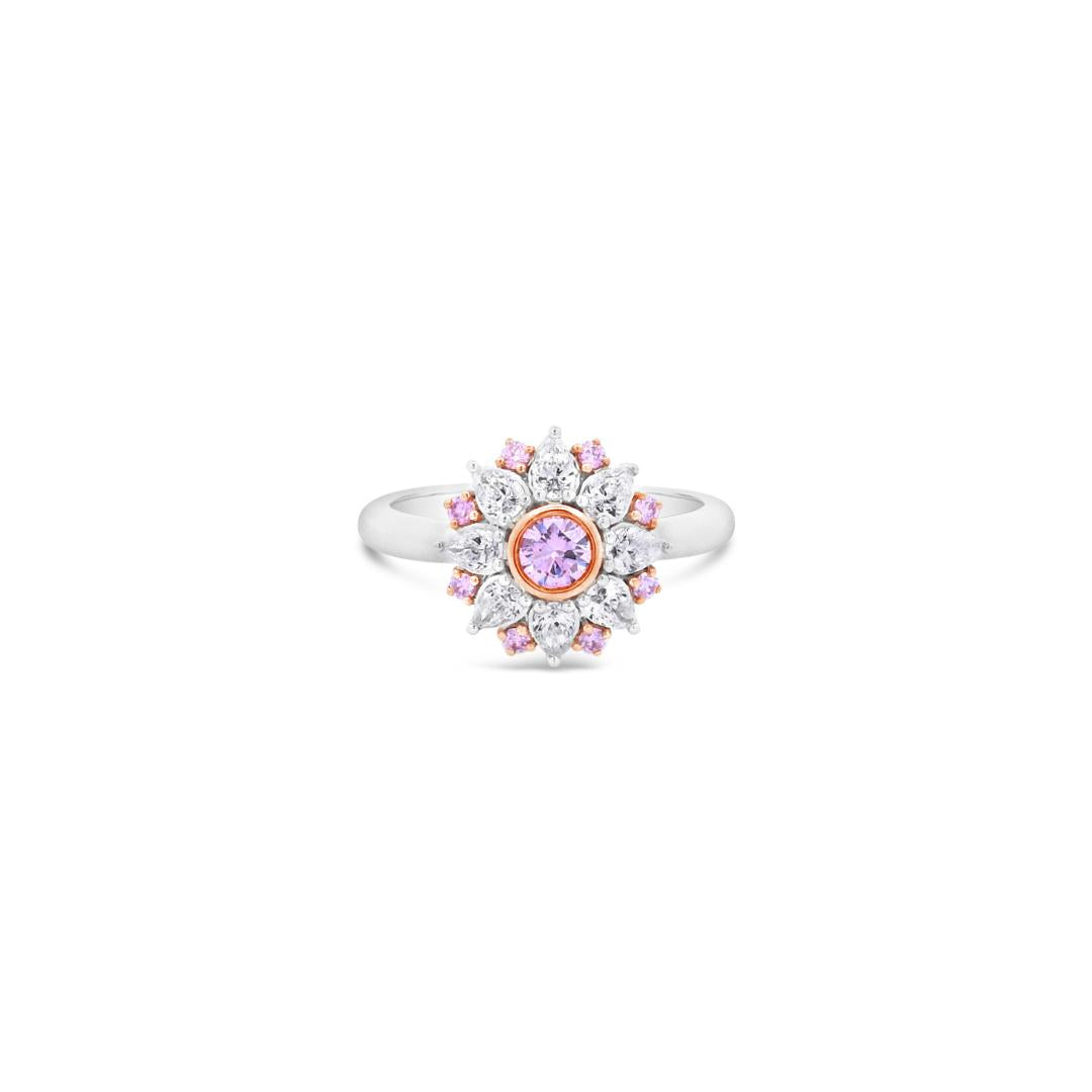 18ct white and rose gold floral ring featuring a central pink diamond, alternating pink and white diamonds, and a finely detailed cut-out back.