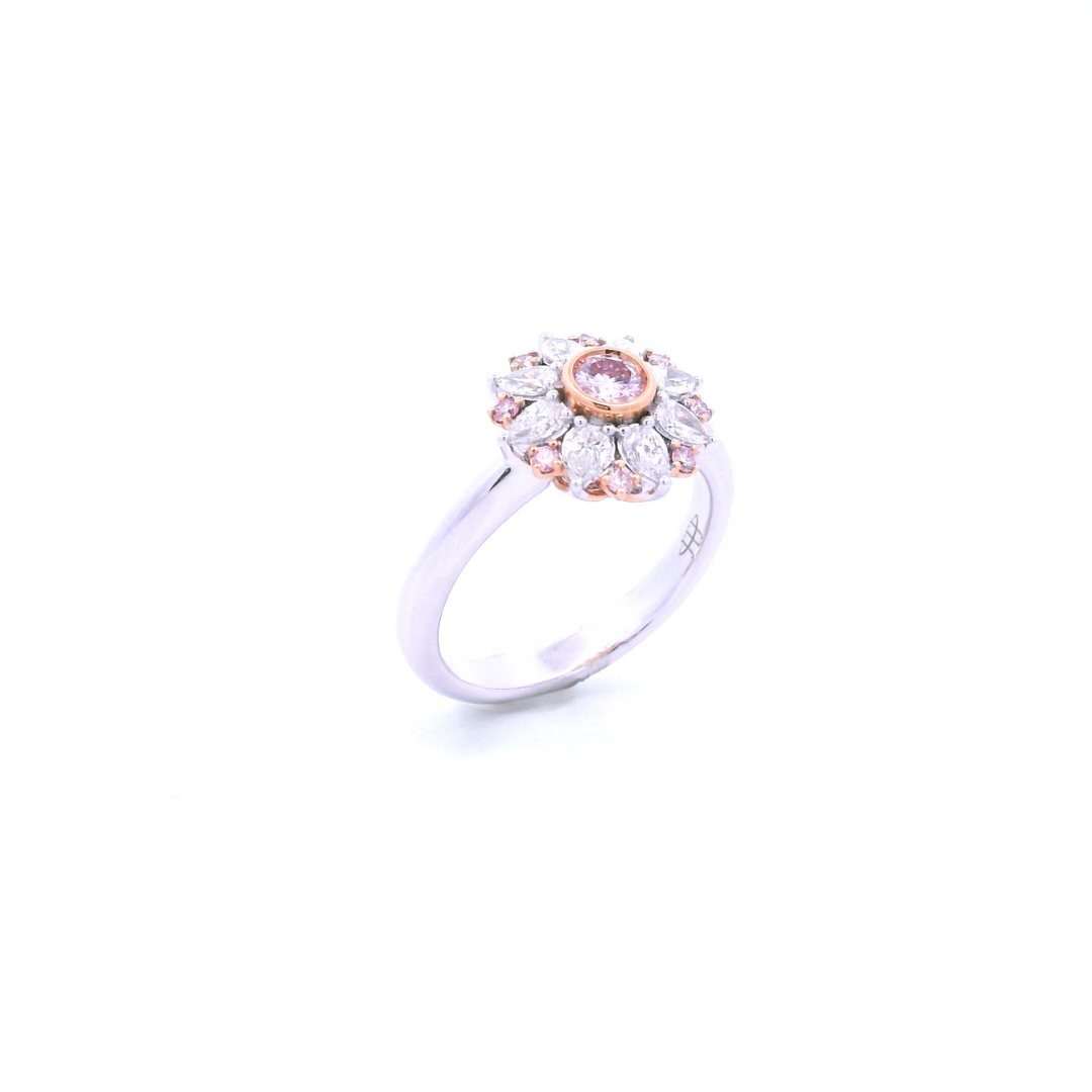 18ct white and rose gold floral ring featuring a central pink diamond, alternating pink and white diamonds, and a finely detailed cut-out back.