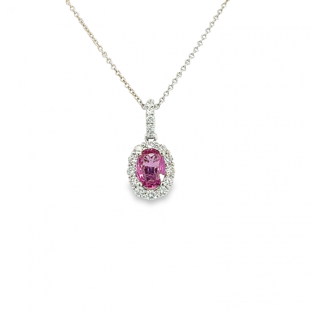 18ct white gold pendant featuring an oval pink sapphire in a four-claw setting with a multi-claw diamond halo and diamond-set pendant runner.