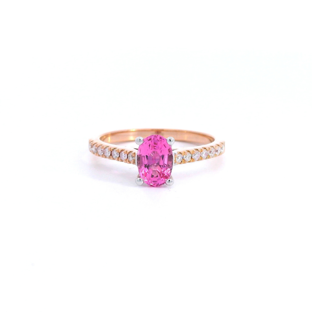 18ct rose and white gold ring featuring a 0.90ct oval cut pink spinel with diamond-set shoulders.
