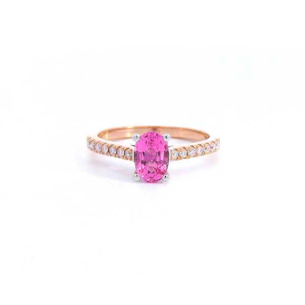 18ct rose and white gold ring featuring a 0.90ct oval cut pink spinel with diamond-set shoulders.