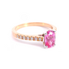 18ct rose and white gold ring featuring a 0.90ct oval cut pink spinel with diamond-set shoulders.