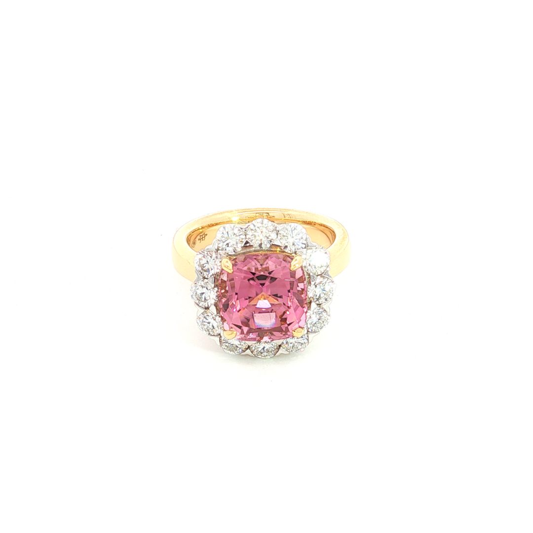 18ct yellow gold ring featuring a 4.50ct cushion-cut pink tourmaline surrounded by 1.48ct round brilliant cut diamonds in a white gold setting.