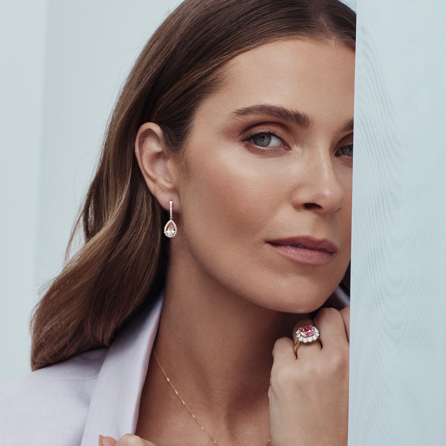 18ct yellow gold ring featuring a 4.50ct cushion-cut pink tourmaline surrounded by 1.48ct round brilliant cut diamonds in a white gold setting.