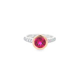 White and rose gold ring with round pink tourmaline and diamond-set shoulders.