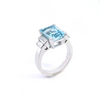 Platinum ring with emerald-cut aquamarine and stepped baguette diamond shoulders.
