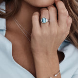 Platinum ring with emerald-cut aquamarine and stepped baguette diamond shoulders.