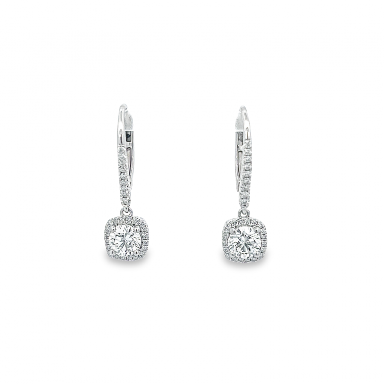 Platinum diamond cluster drop earrings with cushion-shaped halo surrounds.