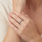 Platinum band with alternating claw-set blue sapphires and diamonds.
