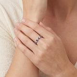 Platinum band with alternating claw-set blue sapphires and diamonds.