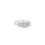 Platinum three-stone diamond ring with tiered round brilliant cut settings.
