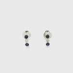 18ct white gold curved bar earrings featuring alternating claw-set sapphires and diamonds, with post and butterfly fittings.