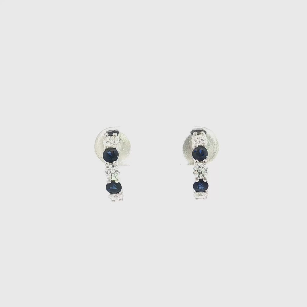 18ct white gold curved bar earrings featuring alternating claw-set sapphires and diamonds, with post and butterfly fittings.