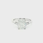Platinum three-stone engagement ring featuring a 2.02ct radiant cut diamond with two pear cut diamond side stones.