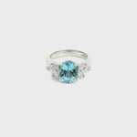 18ct white gold aquamarine and diamond cluster ring featuring a 3.22ct oval aquamarine with oval and pear-cut diamond spray clusters.