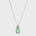 9ct white gold green beryl and diamond pendant with oval green beryl and triangular diamond accent.