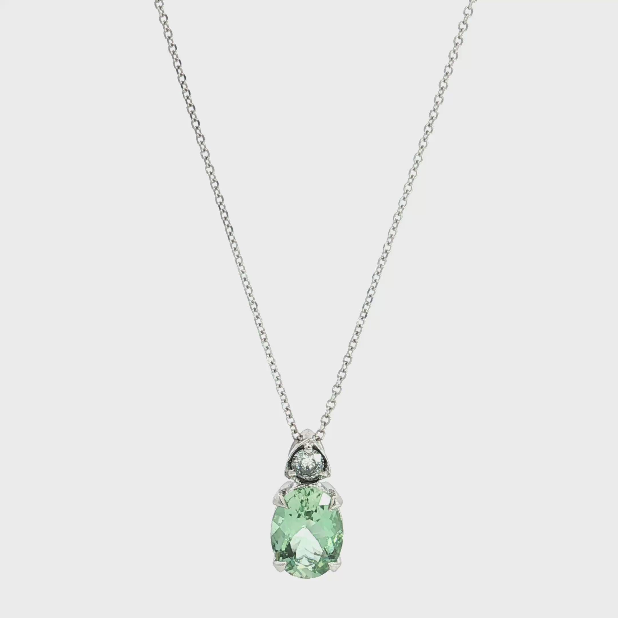 9ct white gold green beryl and diamond pendant with oval green beryl and triangular diamond accent.