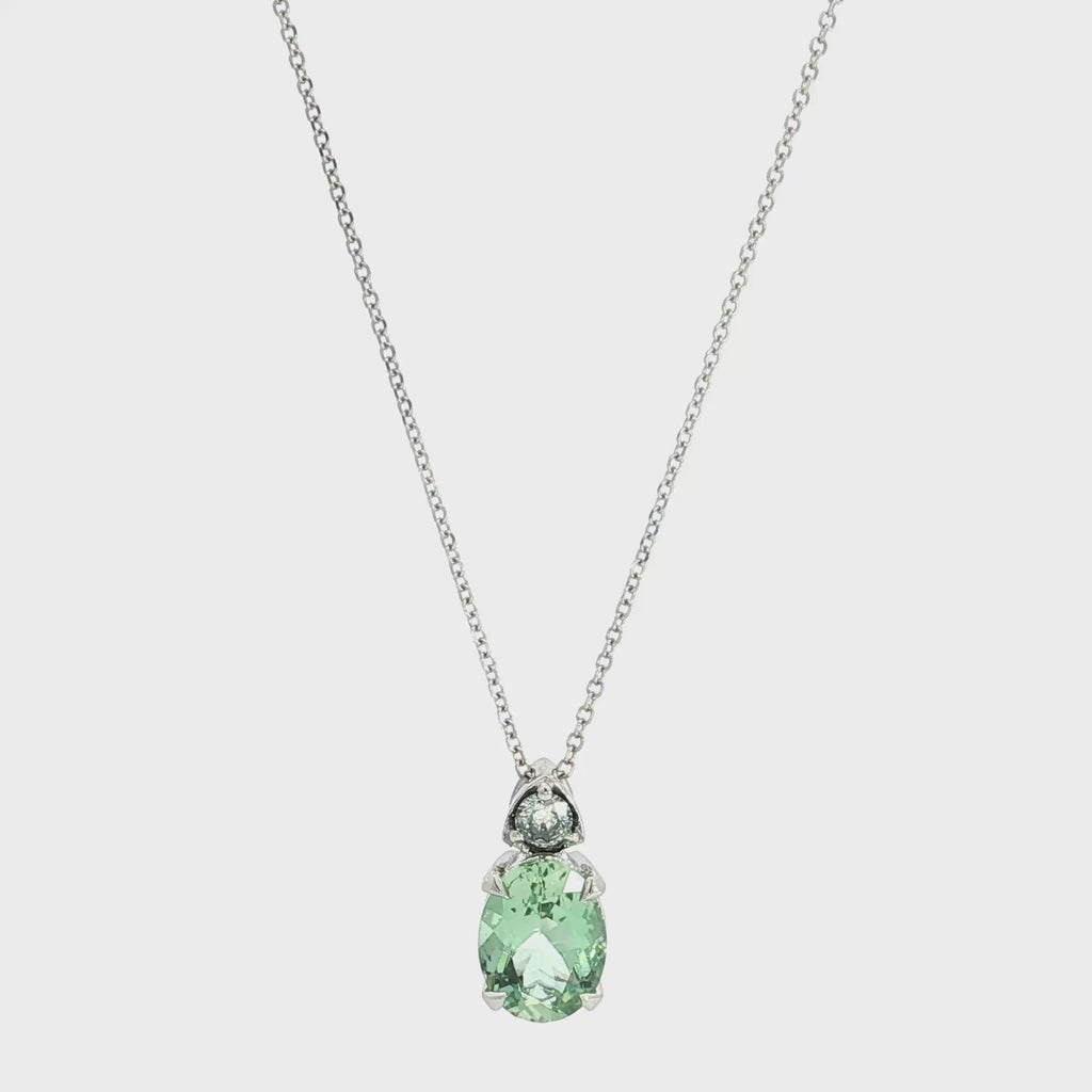 9ct white gold green beryl and diamond pendant with oval green beryl and triangular diamond accent.