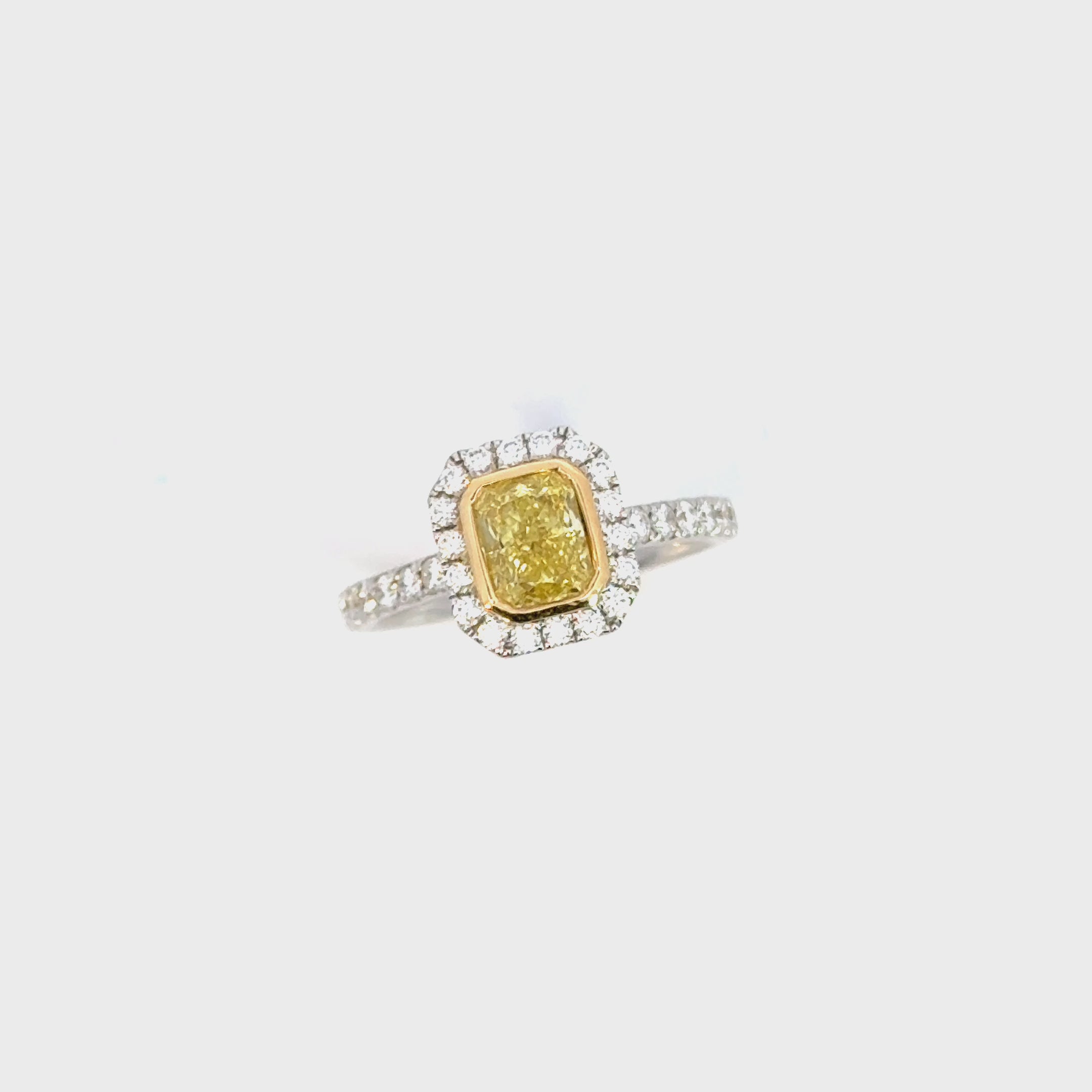 Two-tone 18ct yellow and white gold diamond ring with a 1.01ct Fancy Intense Yellow centre diamond and diamond cluster surround.