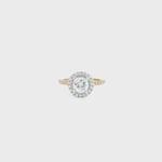 18ct yellow and white gold diamond halo ring featuring a 1.02ct round brilliant cut diamond with a multi-claw halo and diamond-set shoulders.