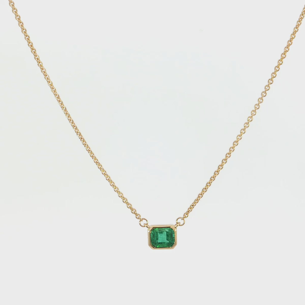 18ct yellow gold necklace with emerald cut emerald set horizontally in bezel