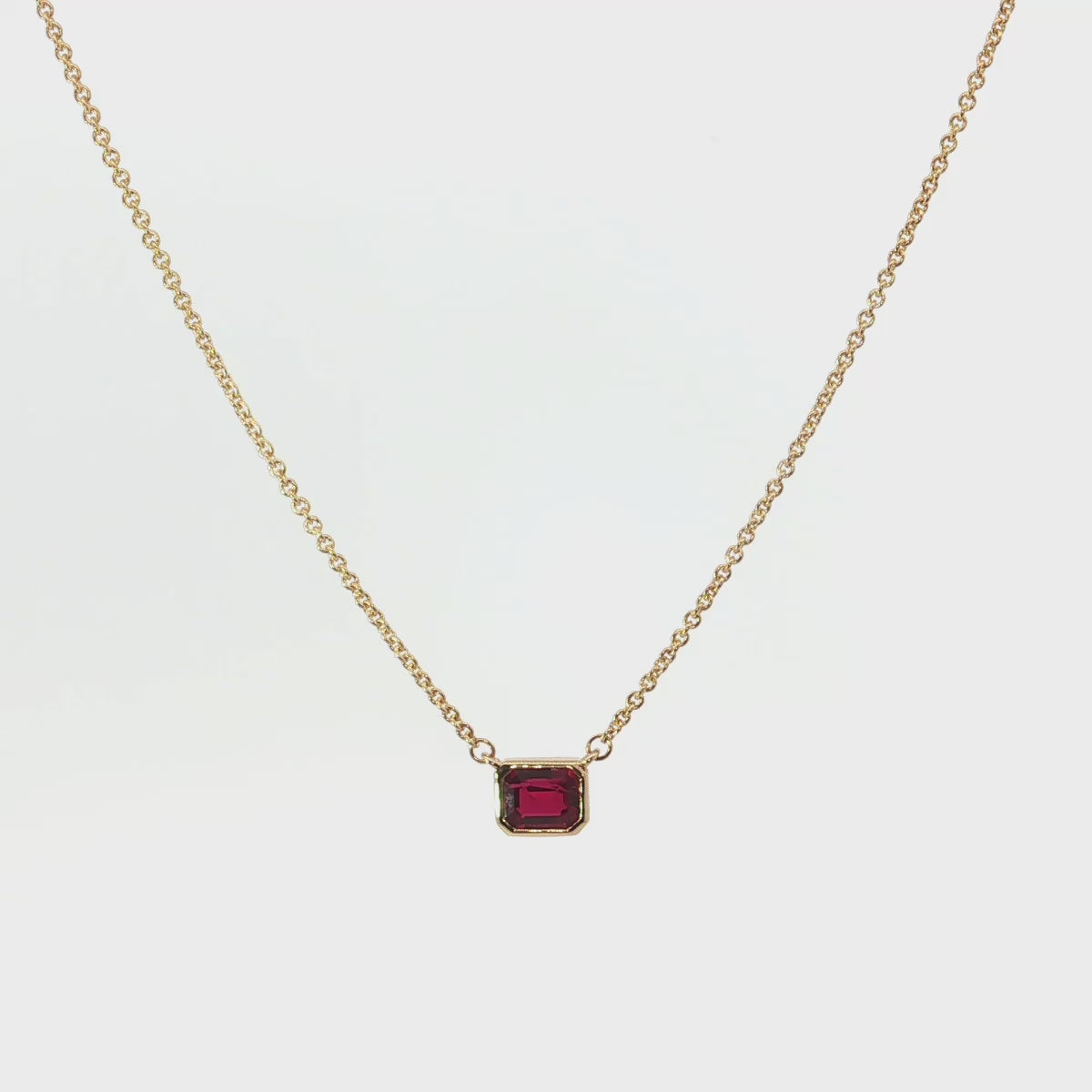 18ct yellow gold necklace with emerald cut ruby set horizontally in bezel
