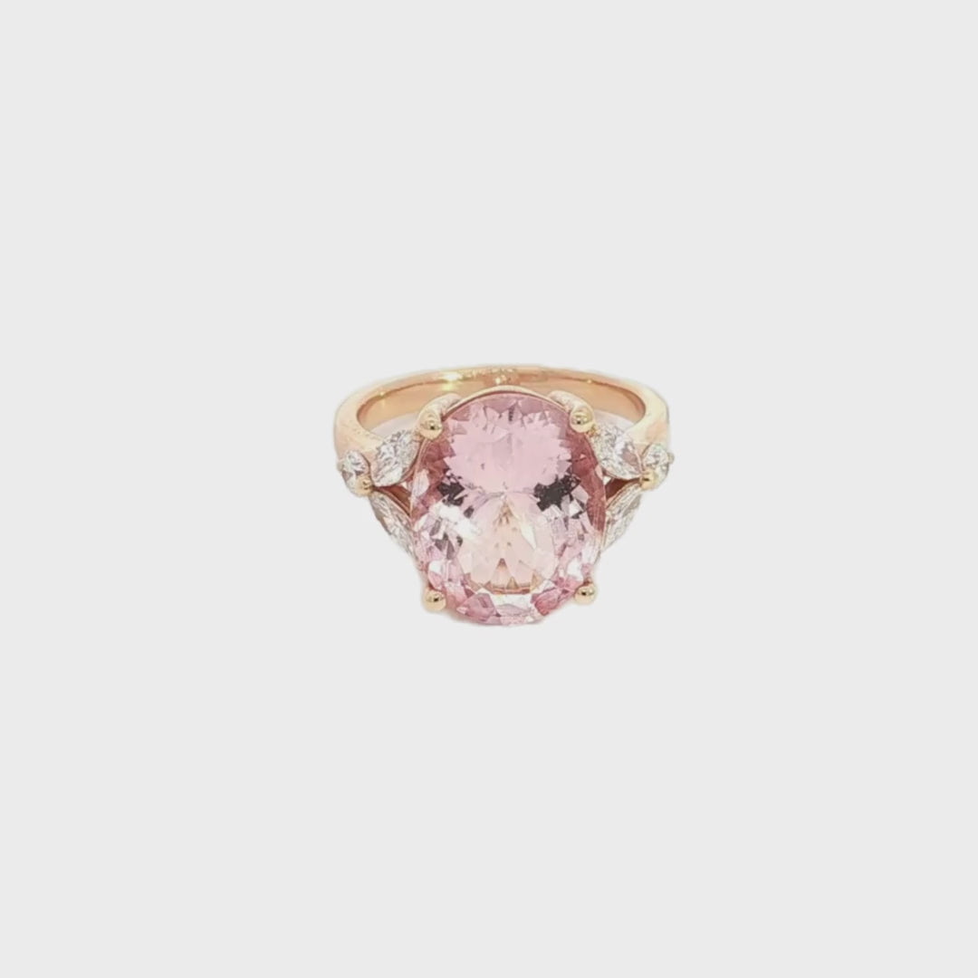 18ct rose gold ring featuring a 5.12ct oval morganite in a four-claw setting with marquise and round diamond accents and a post and bezel undercarriage.