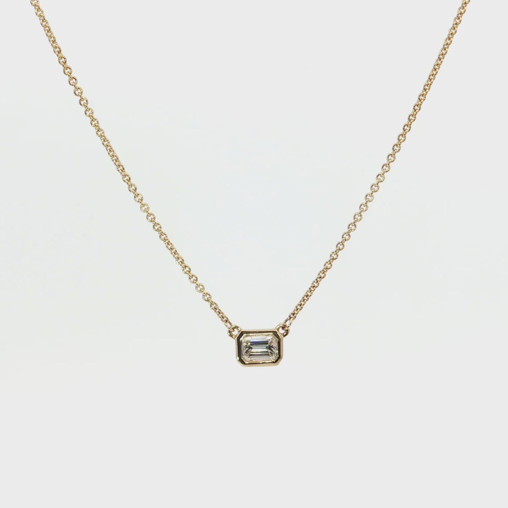 18ct yellow gold necklace with emerald cut diamond set horizontally in bezel