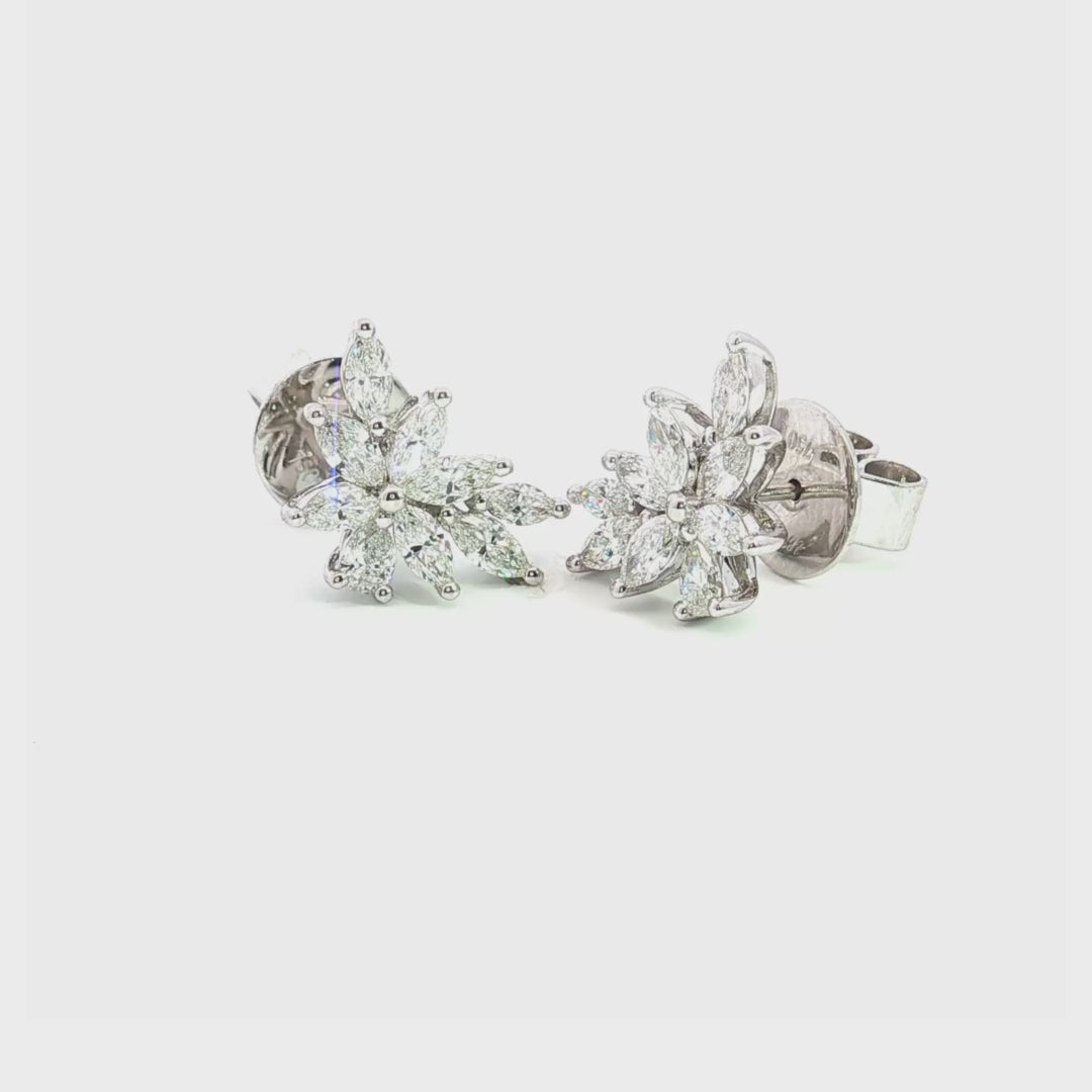 18ct white gold diamond cluster earrings featuring marquise and pear cut diamonds in a tiered multi-claw spray design with post and butterfly fittings.