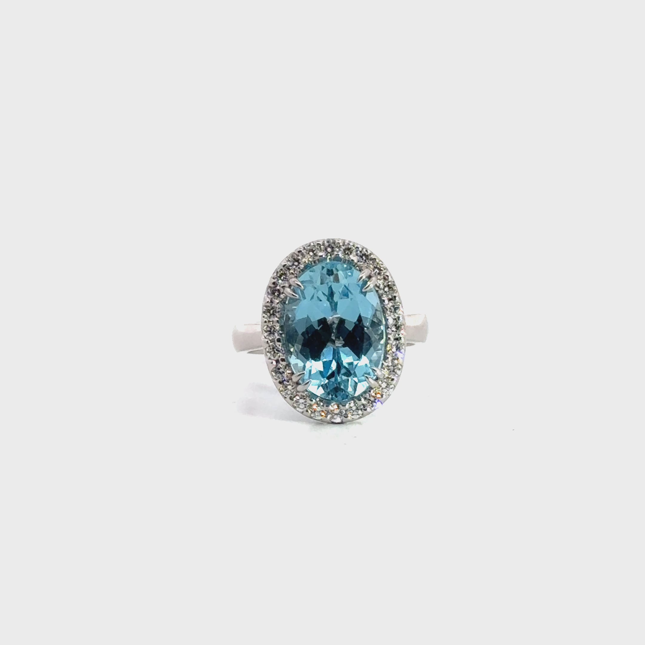 18ct white gold aquamarine and diamond halo ring featuring a 5.38ct oval aquamarine with 24 round brilliant cut diamonds, size N (resizeable).