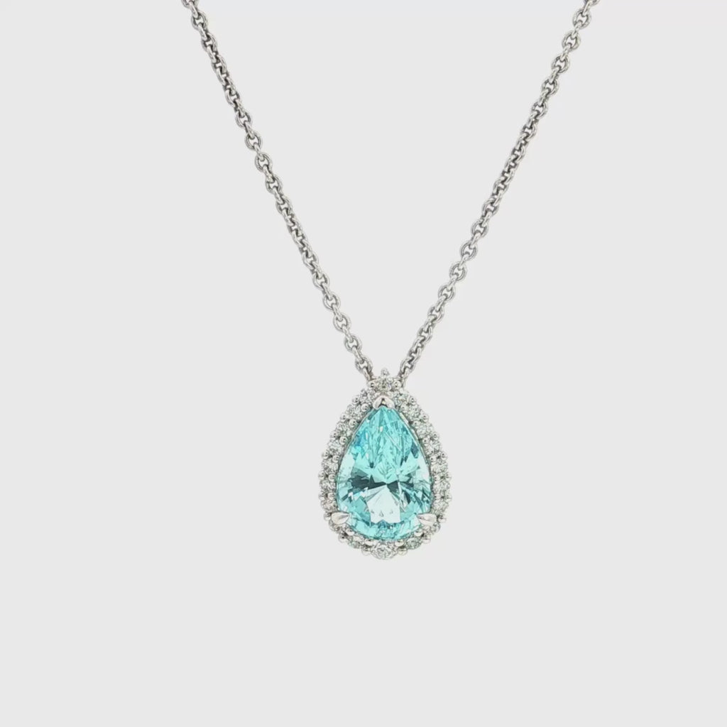 18ct white gold pendant featuring a 3.14ct pear-cut aquamarine in a three-claw setting with a graduated diamond halo surround and concealed pendant runner.