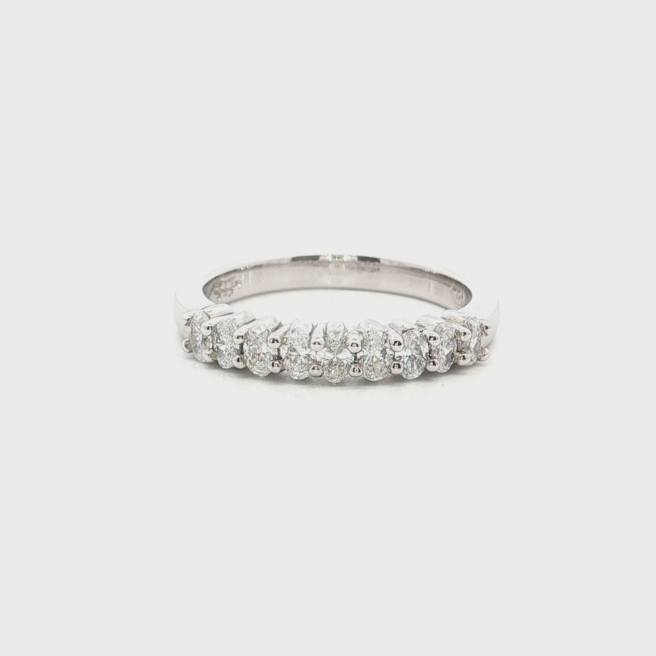 platinum diamond band ring with oval cut diamonds in shared claw setting