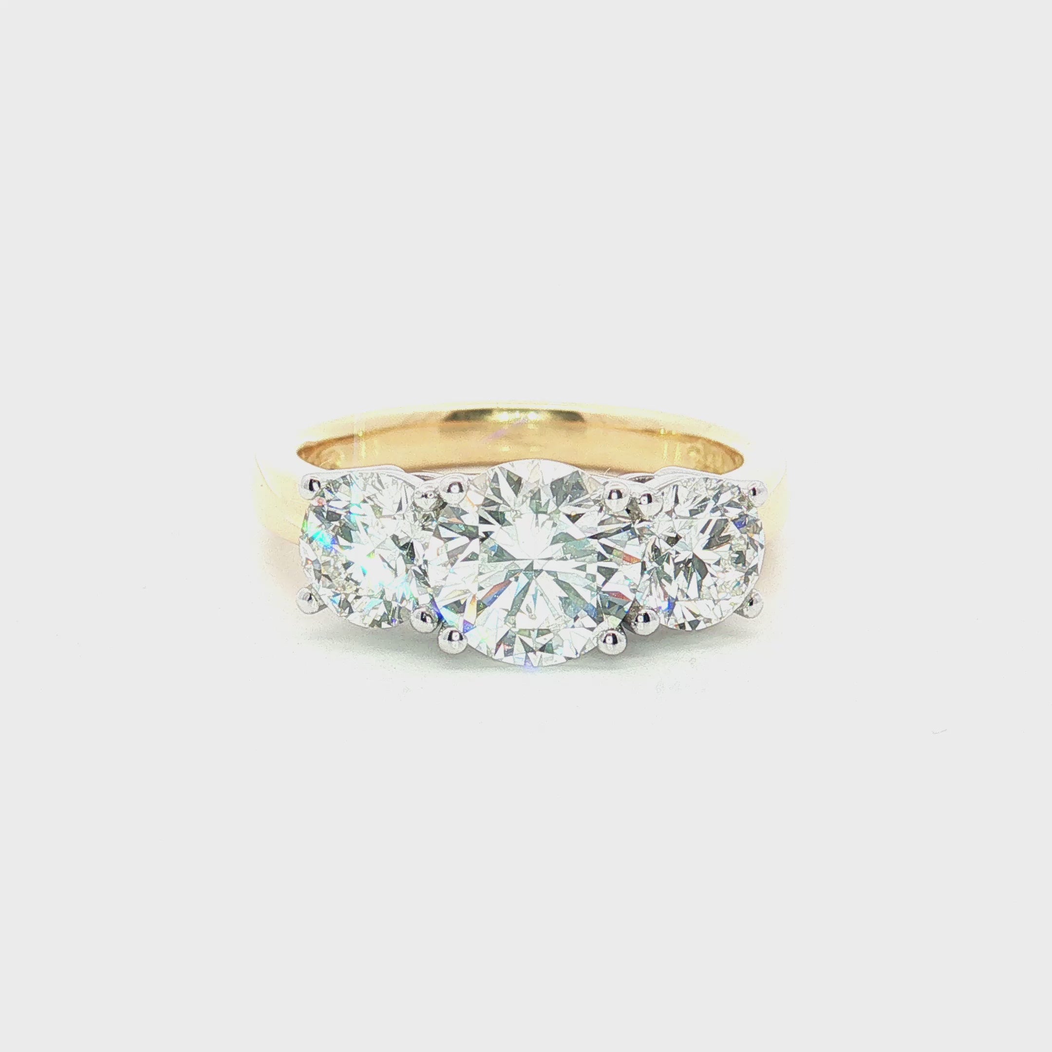 18ct yellow and white gold three stone diamond ring with 1.37ct centre diamond and two round brilliant side diamonds.