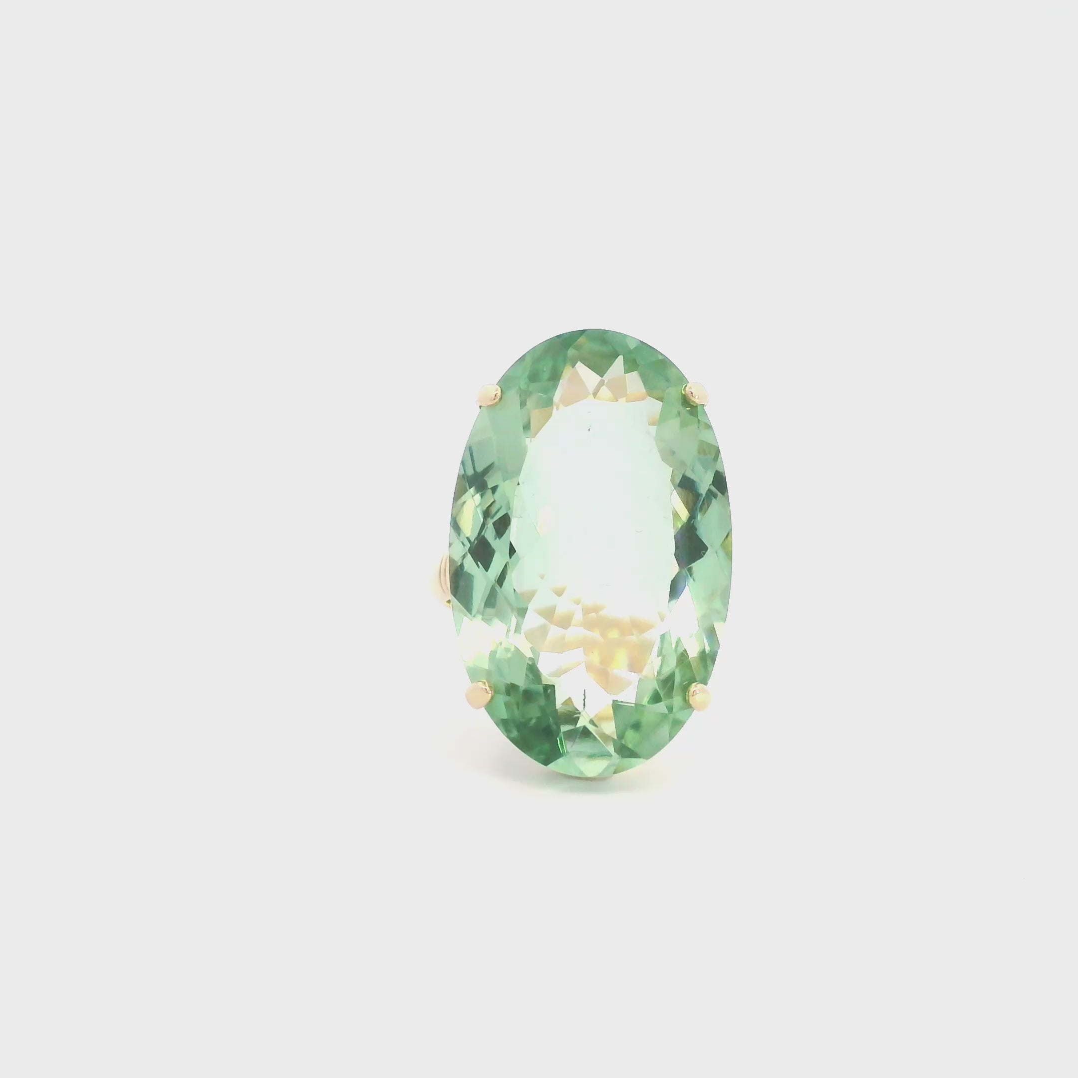 9ct yellow gold ring featuring a large 29 x 18mm oval cut green quartz in a four-claw setting with engraved shoulders.