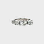 18ct white gold ring featuring seven round brilliant cut diamonds totalling 1.38ct in a straight row shared claw setting with curved undercarriage.