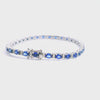 18ct white gold bracelet featuring 31 oval blue sapphires and 62 round brilliant cut diamonds with a box clasp and double figure-eight safety catches.